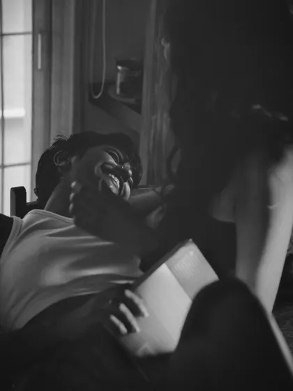 A heartwarming black and white candid shot of two people sharing a laugh. The image is filled with genuine emotion and captures the beauty of an unguarded moment.
