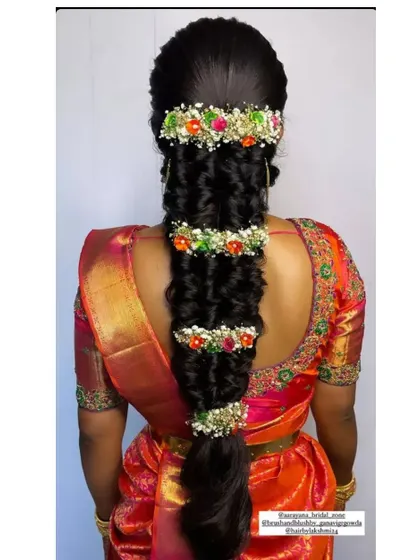 A static image of the grand bridal braid, showcasing the intricate placement of colorful flowers and baby's breath.