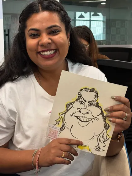 A happy employee from Urbanic with her caricature. It's always a pleasure to bring my art into the workplace.