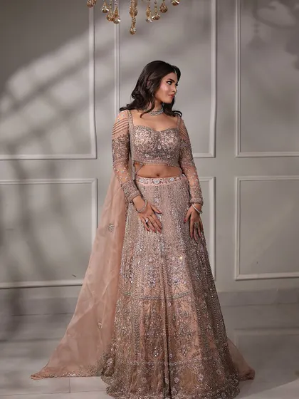 A beautiful shot of the engagement bride, with soft light creating a dreamy effect. Her pastel lehenga and soft makeup are the epitome of modern elegance.