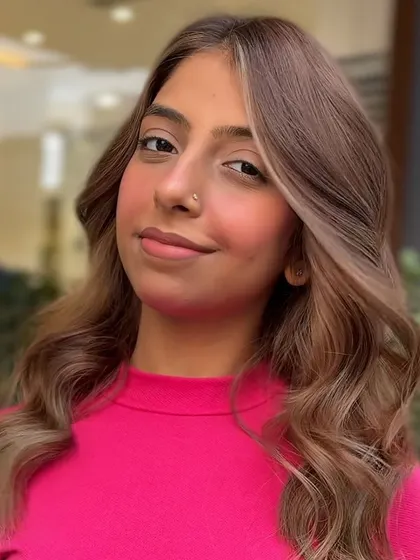 A close-up of the 'money piece' highlights from the classic transformation. The bright blonde strands frame the face beautifully, creating a youthful and radiant effect.