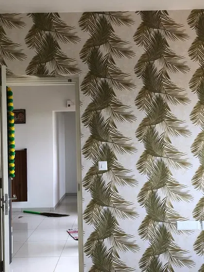 This image shows the palm leaf wallpaper installed in a hallway, demonstrating how a bold pattern can work well in transitional spaces.