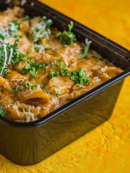 For those who love Italian food, I also offer pasta catering. This image shows a generous portion of creamy penne pasta in a takeaway container, garnished with fresh parsley and cheese. It's a comforting and satisfying meal for any event.