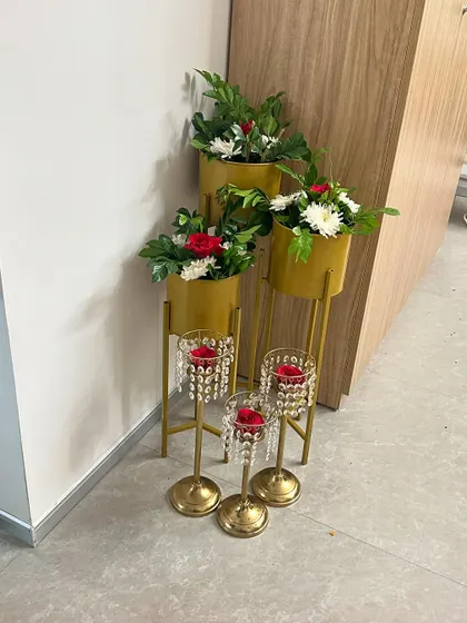 Simple and elegant corner decor for an office, using planters and crystal candle holders.