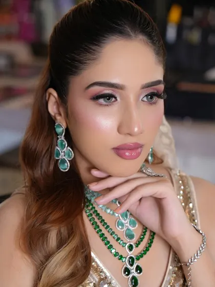 A side profile highlighting the dewy skin and the elegant hairstyle. This is a perfect example of the modern, sophisticated looks I love to create.