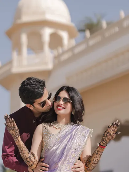 A fun and stylish portrait of the couple in sunglasses at their Jaipur Mehndi.