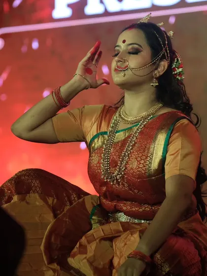 A close-up of the expressive character makeup. The focus is on the eyes and traditional adornments, which are key to storytelling in classical dance and theatre.