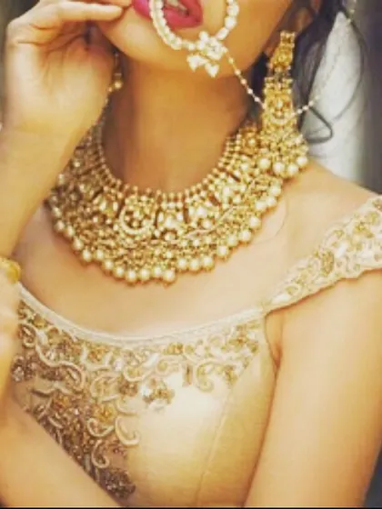 A simple off-shoulder blouse with delicate embroidery along the neckline. This is a versatile design that works well for both sarees and lehengas.