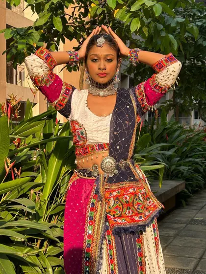A powerful pose showcasing the confidence this outfit inspires. The metallic waist belt and choker are key accessories for this look.