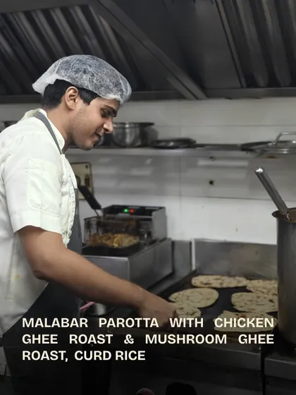 Another chef at the grill, cooking the parottas for the team.