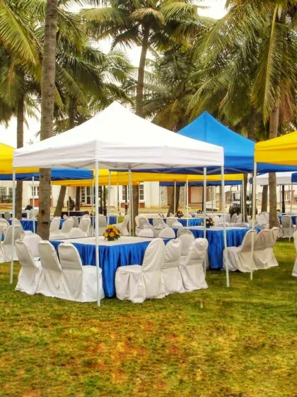 A simple and functional outdoor seating arrangement using multiple gazebos. These tents provide shade for guests and can be set up in various color combinations to match your event theme.