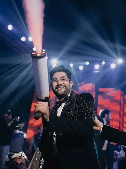 The groom makes a high-energy entrance at his sangeet, using a CO2 smoke gun to hype up the crowd and kick off the party.