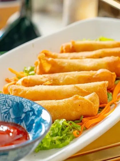 Another shot of our cheese and corn cigar rolls, served with ketchup on a bed of fresh shredded carrots.
