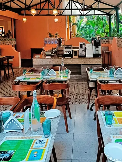 An open-air dining section at our Goa resort project. The terracotta-colored walls, patterned tiles, and surrounding greenery create a dining experience that feels connected to its tropical location.