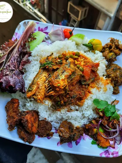 A platter showcasing a variety of my recipes, including sea fish curry, chicken pieces, and spicy chutney.