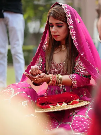 A side profile of the client during the Karwa Chauth puja, showing the elegance of the occasion.
