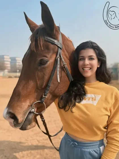 A rider and horse pose for a photo, both looking happy and relaxed in each other's company.
