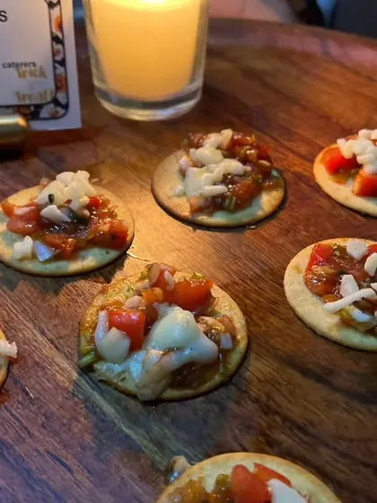A close-up of our "Vampiricious Crackers," which are mini bruschetta bites on crackers, a simple yet delicious appetizer for our Halloween menu.