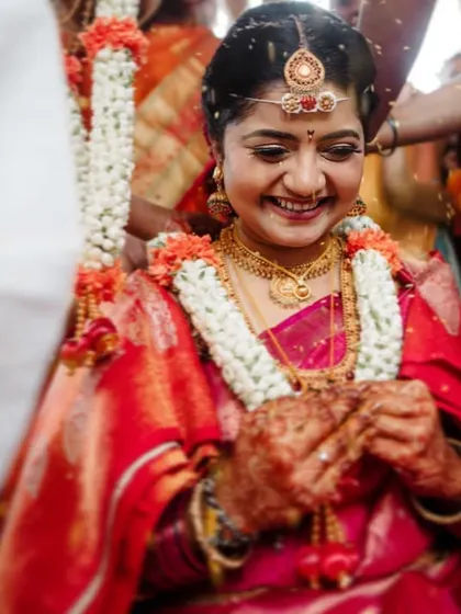 The bride's happy smile during a wedding ritual. We capture the beauty and emotion of these traditions in a natural, unposed way.