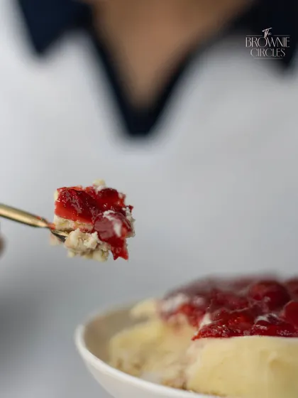 A perfect bite of our strawberry cheesecake, showcasing its creamy texture and fresh topping. It's a delightful treat for any occasion.