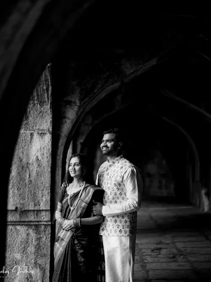 Looking out together. This black and white shot uses light and shadow in a long corridor to create a dramatic and hopeful pre-wedding portrait.