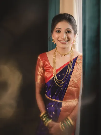 A candid shot of my bride Aditi, her smile lighting up the room. Her natural and radiant makeup highlights her happiness on her special day.