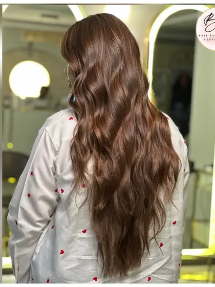 From the back, the length and health of this luminous brown hair are on full display. The color is rich and consistent from roots to ends.