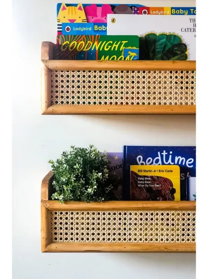 These wall-mounted bookshelves are handcrafted with a beautiful cane weave. They are perfect for creating a small reading nook and displaying your child's favorite bedtime stories.