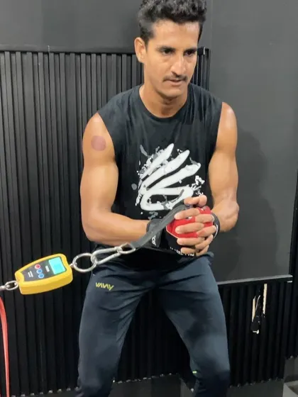 An athlete using a force gauge to measure rotational power during a cable pull, showcasing our data-driven approach to training.