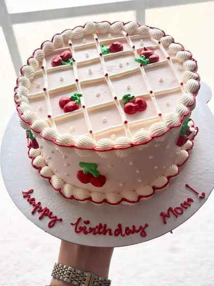 A vintage-style cherry lattice cake for a mom's birthday. The piped details and classic design give it a charming, nostalgic feel.