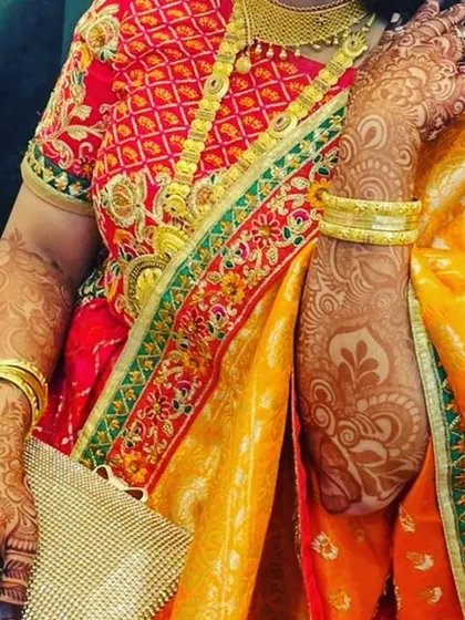 A stunning shot of a client at her brother's engagement. Her rich henna stain perfectly complements her beautiful traditional outfit and gold jewelry.