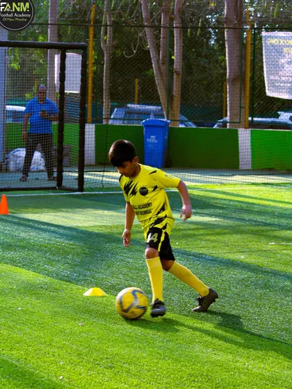 This player is focused on a cone drill, demonstrating the dedication required to master the fundamentals of football.