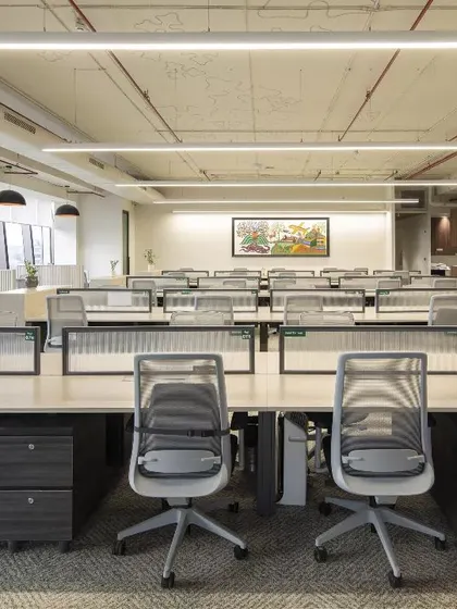 A wide view of the general workstation area at the Carlsberg office. The layout is designed for efficient workflow and team interaction, with ergonomic furniture and ample space, reflecting a modern approach to corporate office design.