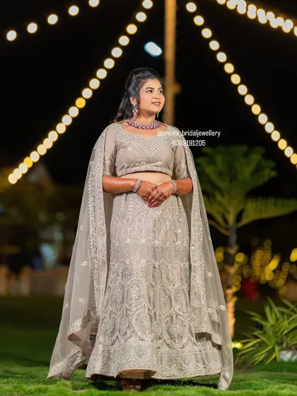 A full-length view of the bride in her reception outfit, showing how a simple, elegant choker can make a statement.