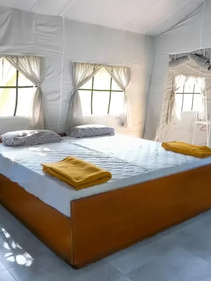 The clean and simple interior of one of our Swiss cottage bedrooms, prepared for a comfortable stay.
