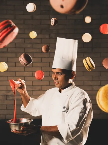 A creative portrait of a pastry chef surrounded by floating macarons. We love collaborating with talented individuals and capturing their personality and craft.