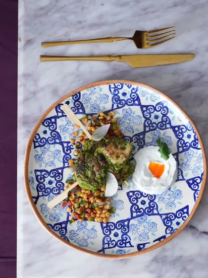 A dish from my four-course lunch menu. This beautiful plate features chicken skewers on a bed of spiced chickpeas, showcasing global flavors.