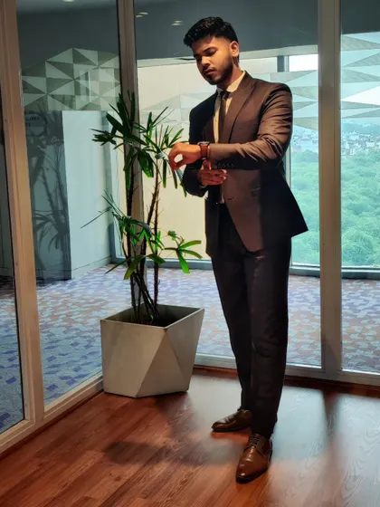 Another angle of the cocoa brown suit, showcasing its fit and how it looks in a professional setting.