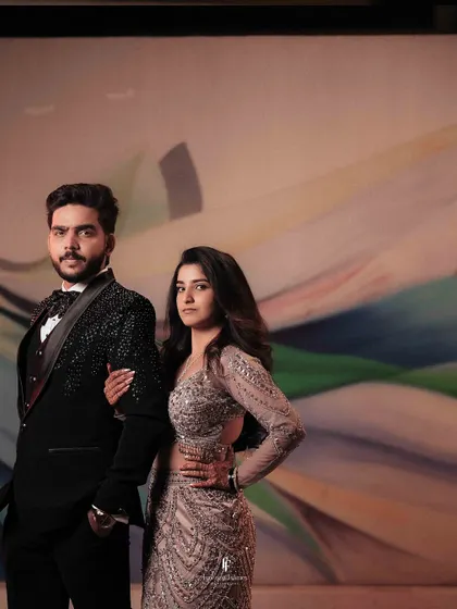 A stylish portrait of the couple against a colorful, abstract background.