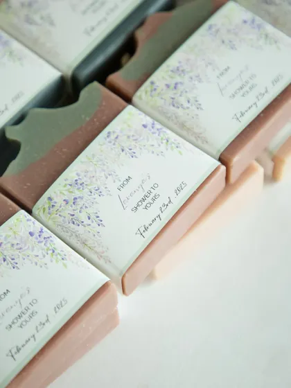 An overhead view of the custom-wrapped baby shower favors, showing the beautiful lavender and sage design.