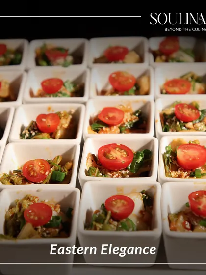Eastern elegance captured in a bite. These small bowls contain a vibrant Asian-inspired salad, topped with a cherry tomato for a pop of colour and freshness.