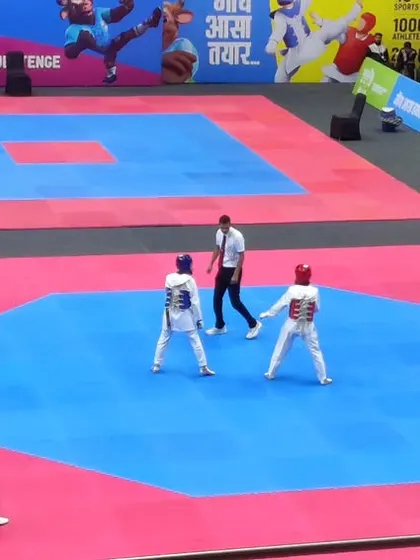 A view of the action on the mat at the National Games. Two athletes compete with precision and intensity in the octagonal ring.