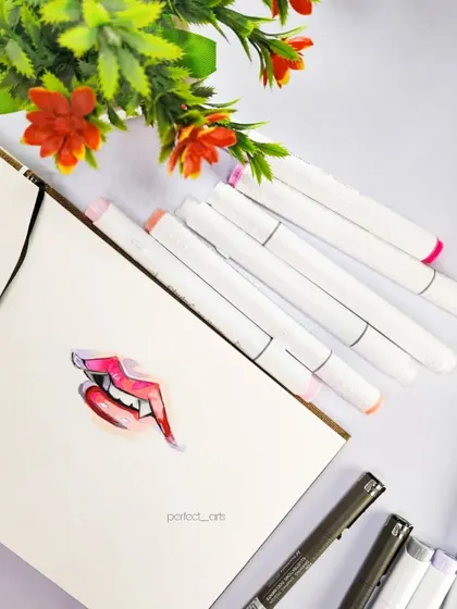 The finished vampire lips drawing. I used various shades of red and pink markers to create a gradient effect and added white highlights to make them look glossy.