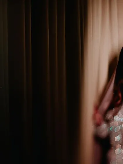 A portrait of a Muslim bride in a stunningly embellished gown, with a creative text overlay.