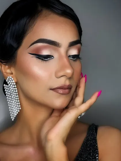 A classic party look featuring a sharp, double-winged eyeliner. This style is sophisticated and modern, perfect for making a statement at any event.