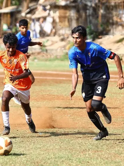 A defender closely marks an attacker, showcasing the tactical discipline we instill in our players.