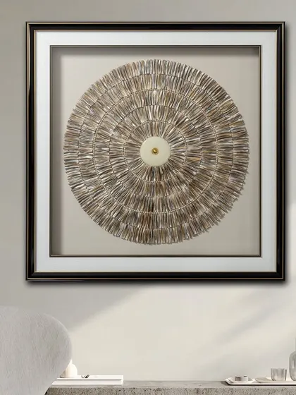 The Echoes of Orbit shadow box is a stunning decorative piece for contemporary spaces. The circular design is created with textured, layered elements that draw the eye to the center, creating a focal point.