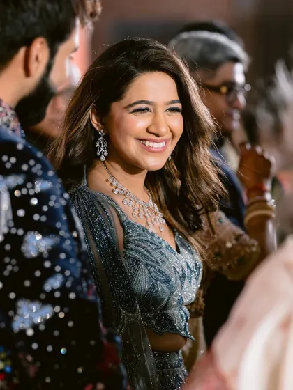 A candid moment of the bride interacting with guests, her makeup looking fresh and beautiful all night long.