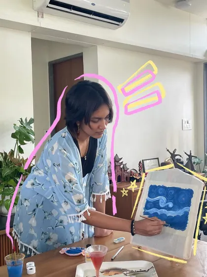 A behind-the-scenes shot of me painting a Starry Night design on a lantern for a workshop.