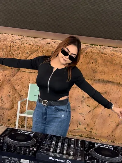 Arms outstretched, feeling the vibe at an outdoor event. Work vibes on point.
